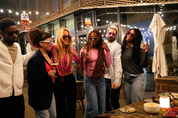 istock Cheerful multi-ethnic friends enjoying drinks at a rooftop party 2192531903