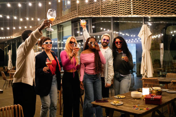 istock Cheerful multi-ethnic friends raising toast at a rooftop party 2192531904