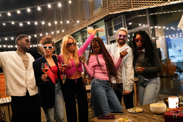 istock Multiethnic friends enjoying rooftop party with drinks and dancing 2192531905