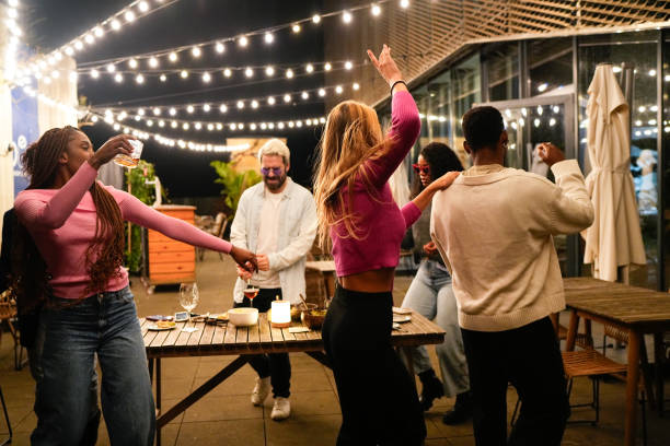istock Young people dancing and drinking at rooftop party 2192532019
