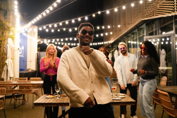 istock Young man dancing with friends at a rooftop party 2192532032