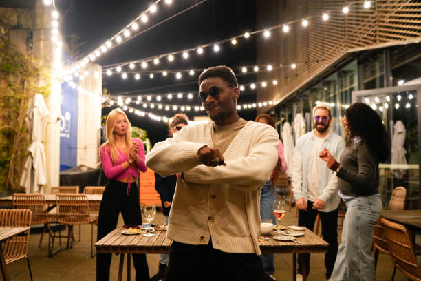 istock Young man dancing with friends at a rooftop party 2192532036