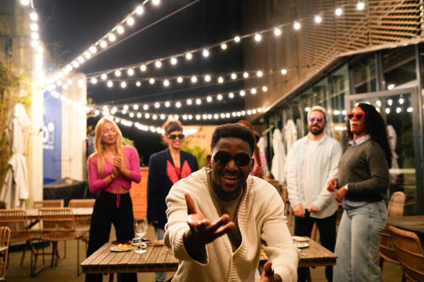 istock Young man dancing with friends at rooftop party 2192532037