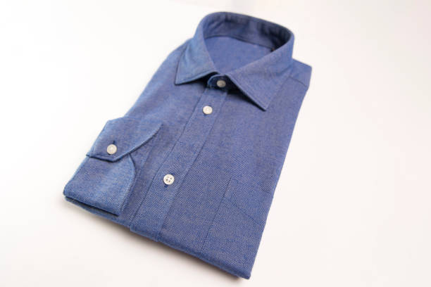 Close up on a blue man shirt on a white background.