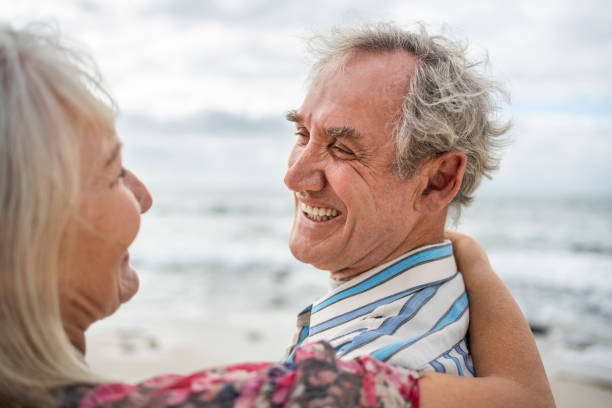 istock Loving senior couple smiling at each other on beach 2192532156