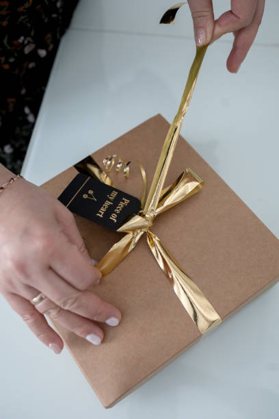 istock A woman wraps a gift . The process of packaging an environmentally friendly gift.Focus on the box 2192534819
