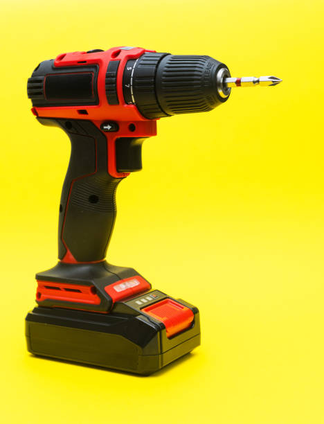 istock modern cordless screwdriver on a yellow background. vertical 2192535053