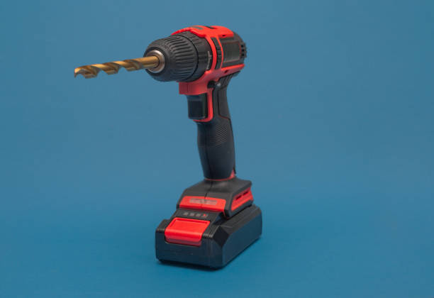 a cordless screwdriver with a drill bit on a blue background.