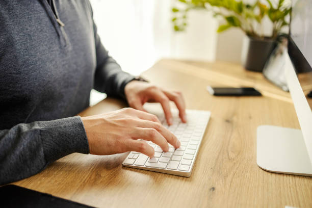 istock Close up of hands on keyboard at home office. 2192535116
