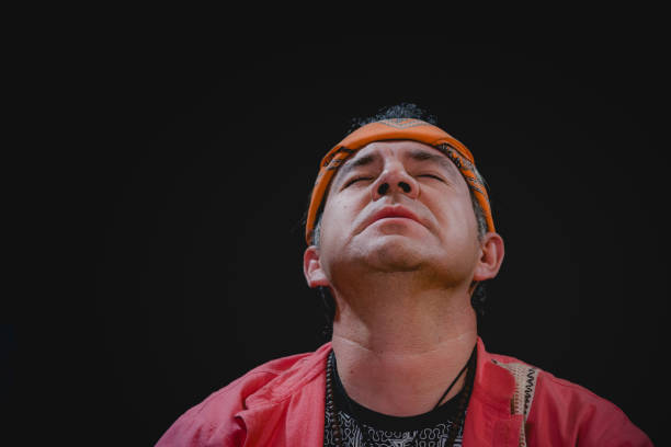 Shaman giving thanks during pre-hispanic ritual with medicinal plants