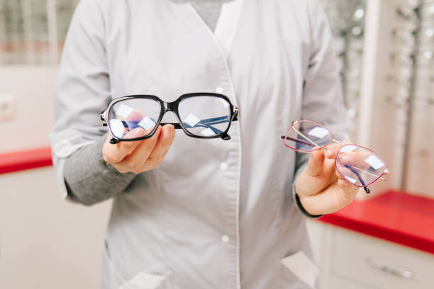 istock Ophthalmologist offers eyeglasses with different frames after checkup in the optical clinic. Correcting eye diseases using glasses with clear lenses. 2192539057
