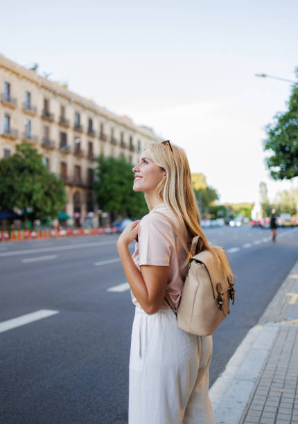 istock Tourist waiting for transportation in urban setting 2192539459