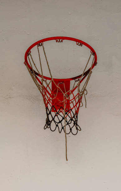 istock Basketball hoop hanging from ceiling against white wall in indoor space during daylight hours 2192539807