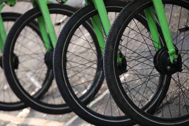 Line of parked bicycle tyres with green forks