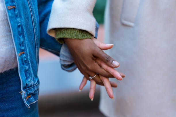 istock Two young women holding hands, showing support and friendship 2192541276