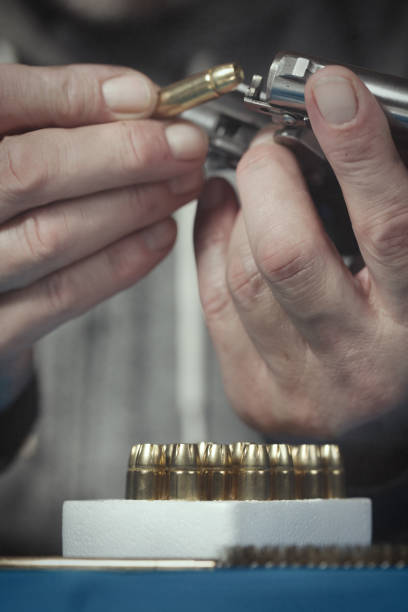 istock Checking, cleaning and loading of small derringer .38 special handgun by man 2192541483