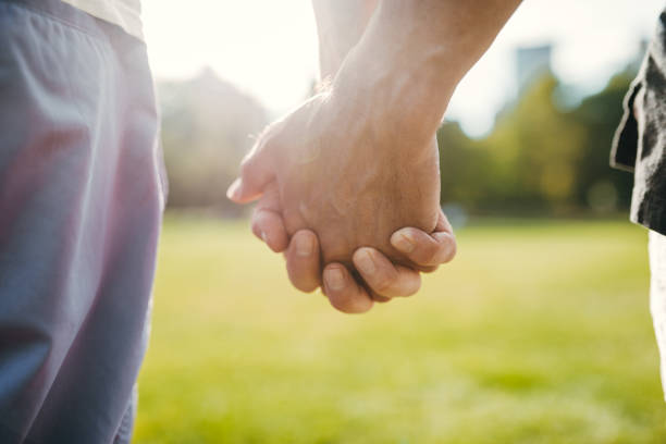 istock gay couple having fun in the park 2192544529