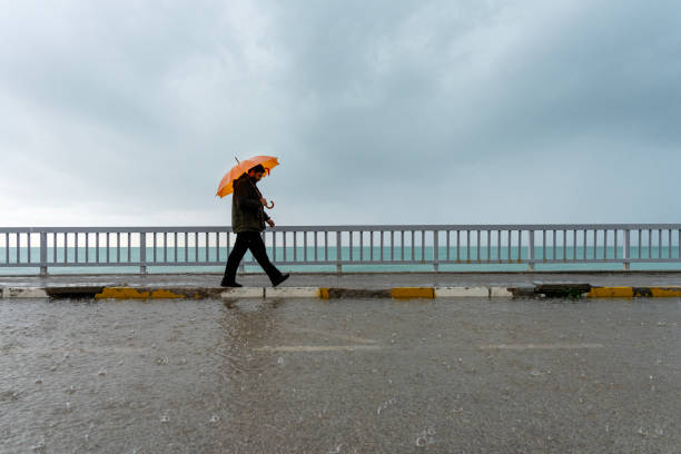 istock Man walking in the rain 2192544560