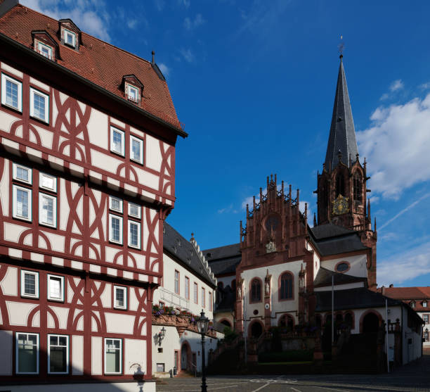 Historic Half-Timbered Building with Gothic Church in European Town Square