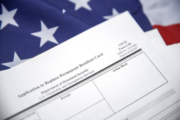 istock USA permanent resident card replacement form with flag in the backdrop. Copy space PR replacement card form I-90 2192551366