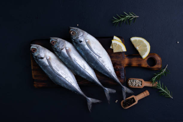 istock Raw mackerel, seafood, ready to cook on black background 2192552474