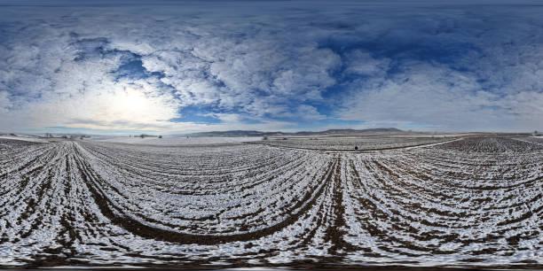 Owner looking at his agricultural fields covered with snow