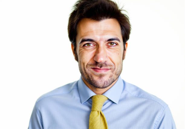 passport type picture of a young man with glasses and a mauve tie on white background