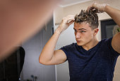 young-man-applying-hair-dye-in-modern-ba