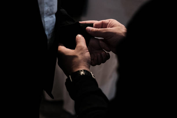 istock Wedding Preparation: ring bearer's cuff links fastened by his father 2192560412