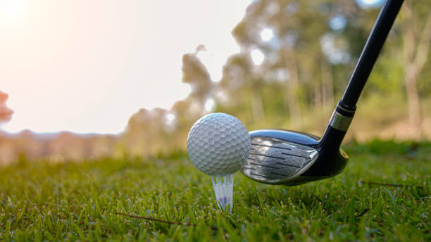 istock Golf ball and golf club in beautiful golf course at sunset background 2192560587
