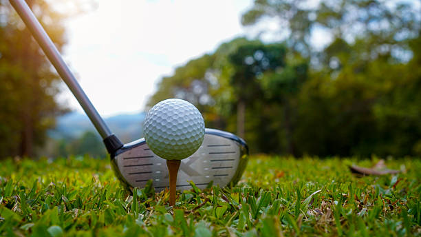 istock Golf ball and golf club in beautiful golf course at sunset background 2192560599