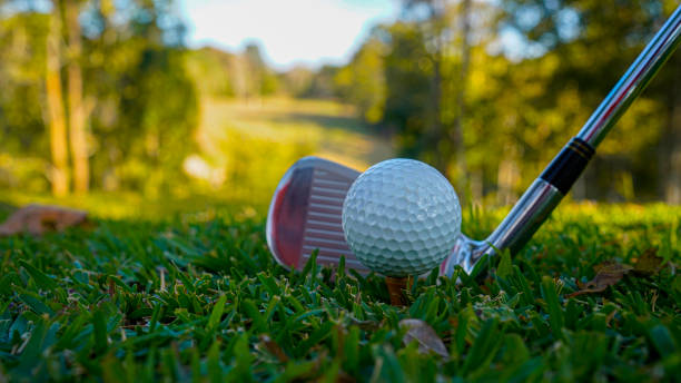 istock Golf ball and golf club in beautiful golf course at sunset background 2192560613