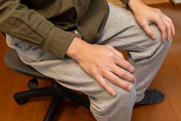 istock A man sitting on a chair with his hands on his knees 2192560762