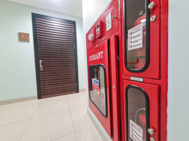 istock hydrant box with fire extinguisher next to a toilet door inside office building. Emergency fire exit prevention. 2192560808