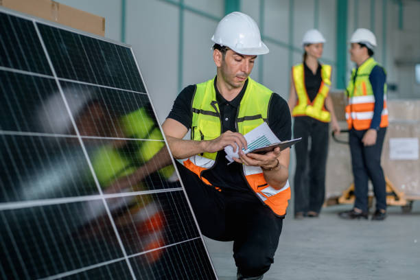 istock man in a yellow vest is looking at a tablet while standing next to a solar pan 2192570931