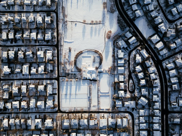 Community neighborhood single family houses backyard with snow covered trees shrubs homes after Christmas blizzard white storm in northern Virginia suburbs landscape with nobody