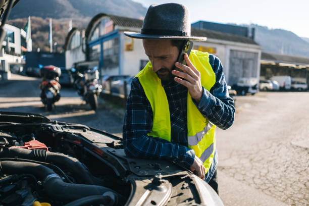 istock Man uses mobile phone near vehicle break down 2192572934