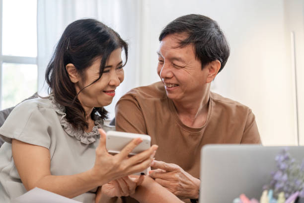 istock Elderly Couple Managing Finances Together at Home with Calculator and Documents for Budget Planning and Expense Tracking 2192574874