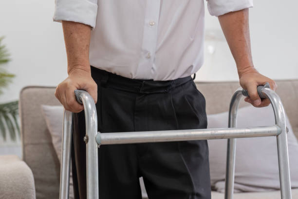 istock Elderly Man Walking with Cane for Support in a Bright Indoor Setting, Emphasizing Independence and Mobility in Senior Life 2192578542