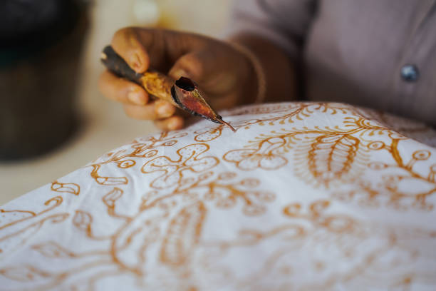 istock The process of making Indonesian batik with Lasem batik motifs. Making batik, making hand-drawn batik on white cloth 2192578896