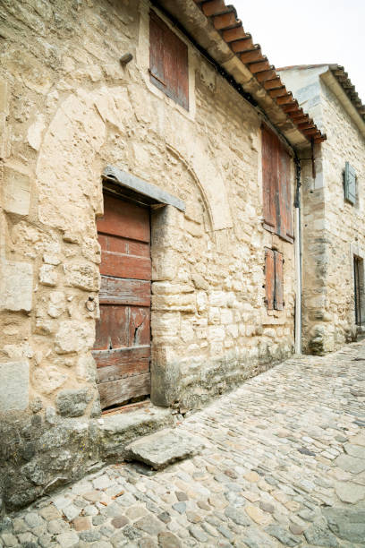 Cobblestone lane leading through tiny Lacoste village, Provence, France
