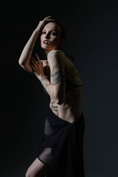 Midsection Of Woman With Tattoo Text On Hand