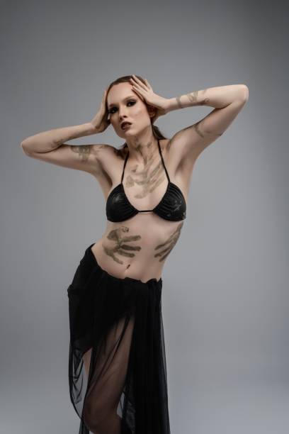 Artistic dance performance by a model wearing elegant black attire indoors
