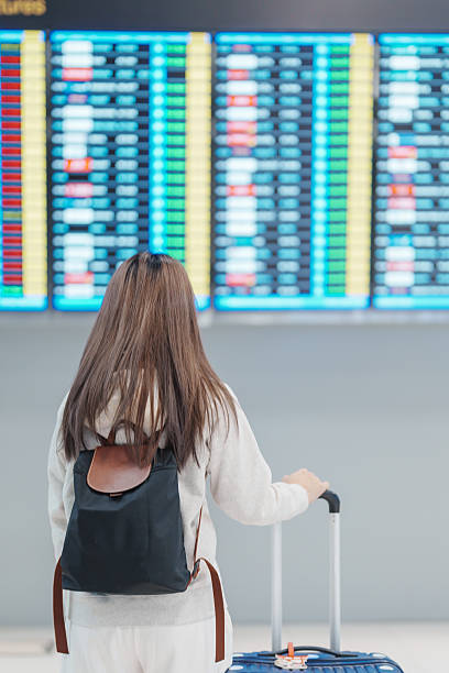 istock Young woman hand holding luggage handle before checking flight time in airport, Transport, insurance, travel and vacation concepts 2192590708