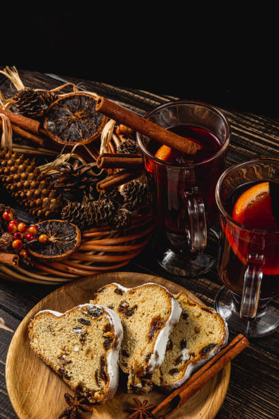 istock Mulled wine with cinnamon sticks and stollen on a wooden table 2192593499
