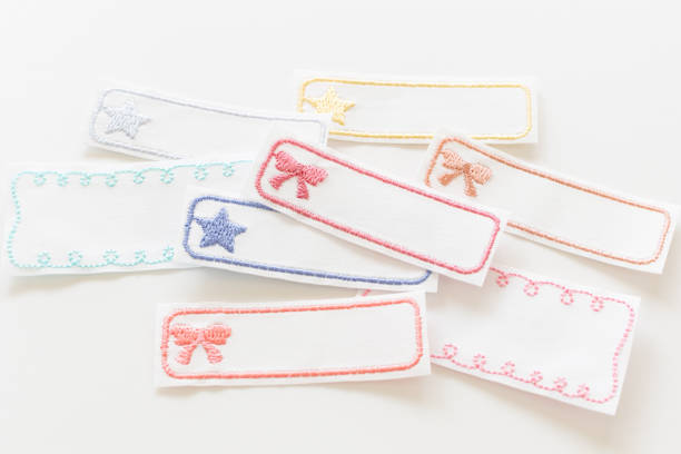 Yellow silk ribbon and bow, blue paper tag for congratulations. Isolated background
