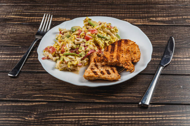 Delicious Grilled turkey Served with a salad on a Rustic Wooden Dining Table High quality photo.