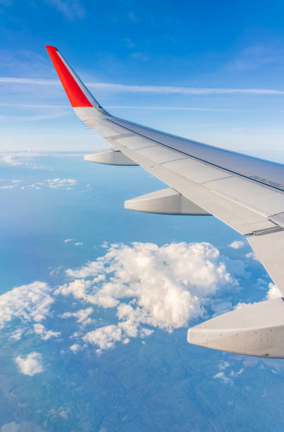 istock View from the airplane window at a beautiful cloudy sky and the airplane wing 2192597111
