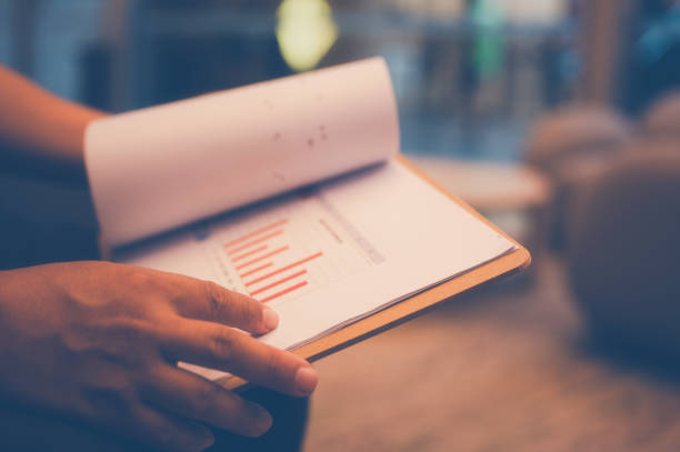 istock Businessman holding a clipboard with chart report , An analyst uses a dashboard for data business analysis and Data Management System, Customers database, gather information to report 2192597333
