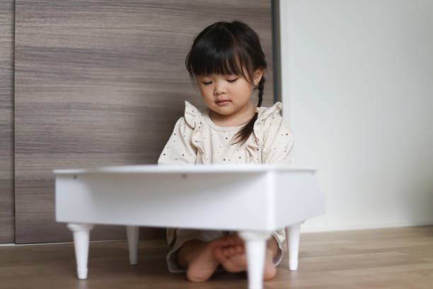 istock Little girl playing piano 2192598855